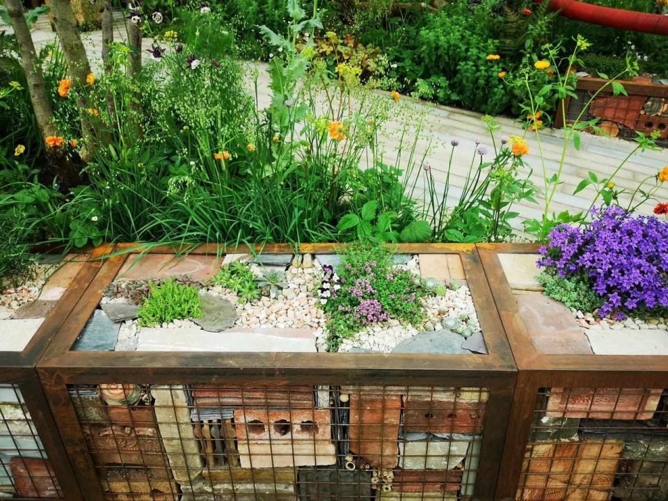 a patio with a deck and plants