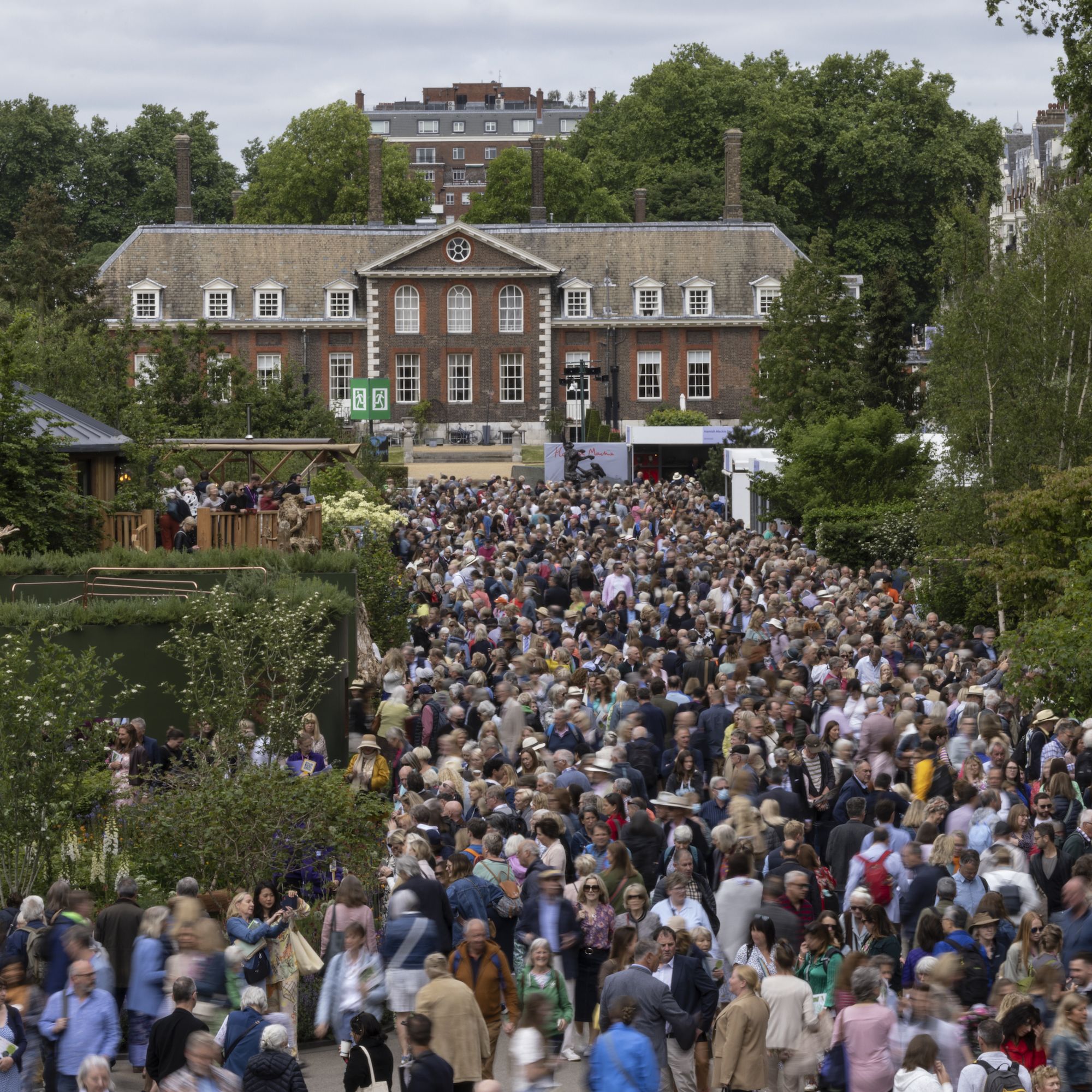 london, england may 26 crowds on the main avenue at chelsea flower show on may 26, 2022 in london, england the chelsea flower show returns to its usual place in the horticultural calendar after being cancelled in 2020 and postponed in 2021 due to the covid pandemic this year sees the show celebrate the queen's platinum jubilee and also a theme of calm and mindfulness running through the garden designs photo by dan kitwoodgetty images