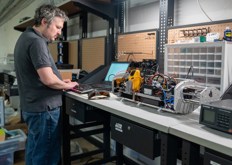 Electrical engineer Cody Hyman prepares for a test of Impossible Sensing’s prototype soil sensor in St. Louis. The machine is designed to be mounted to the back of a planter and can measure soil composition in real time using a powerful laser.