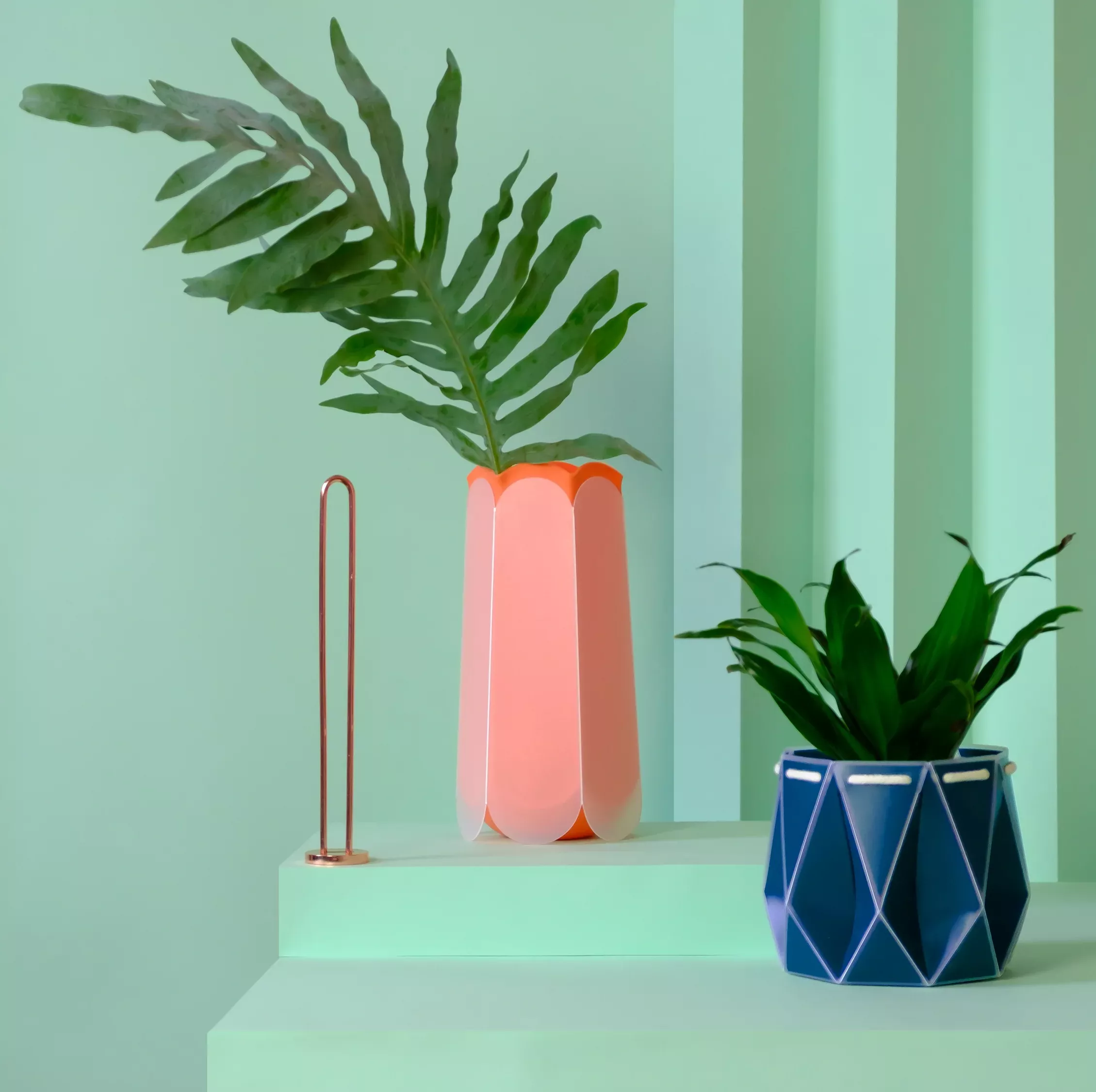 two of potr's origami plant pots on a turquoise background